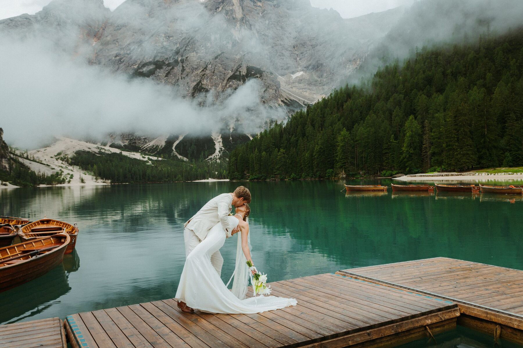 Couple sharing a moment on a jetty by an alpine lake