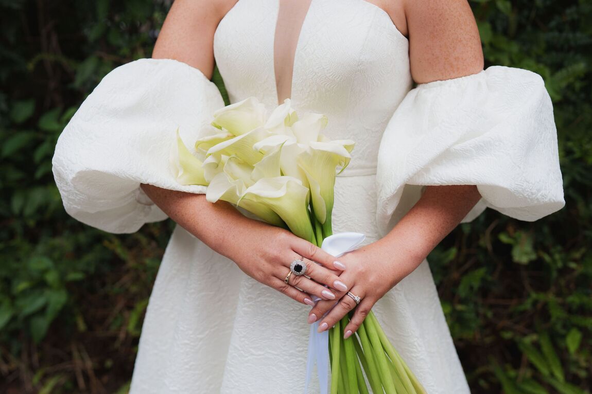 Bride holding a white calla lily bouquet