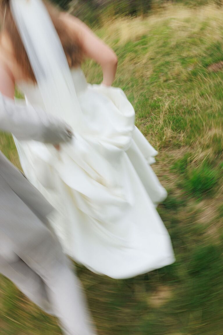 Bride moving through a field, motion blur