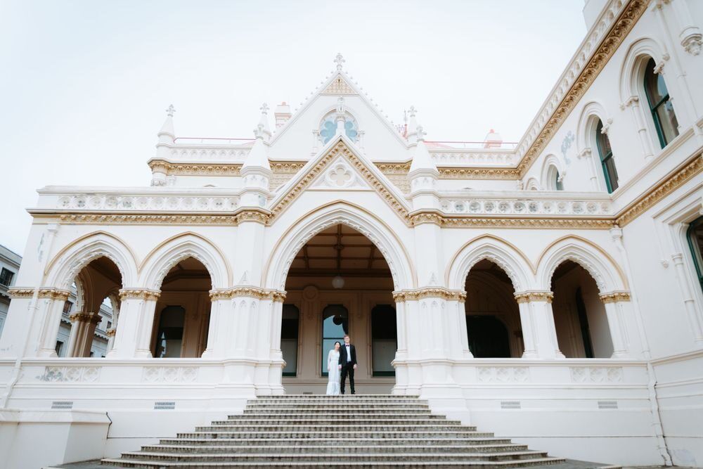 Bride and groom on the steps of a grand heritage building